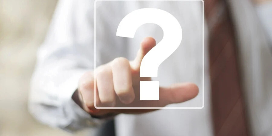 man in shirt and tie with hand touching question mark