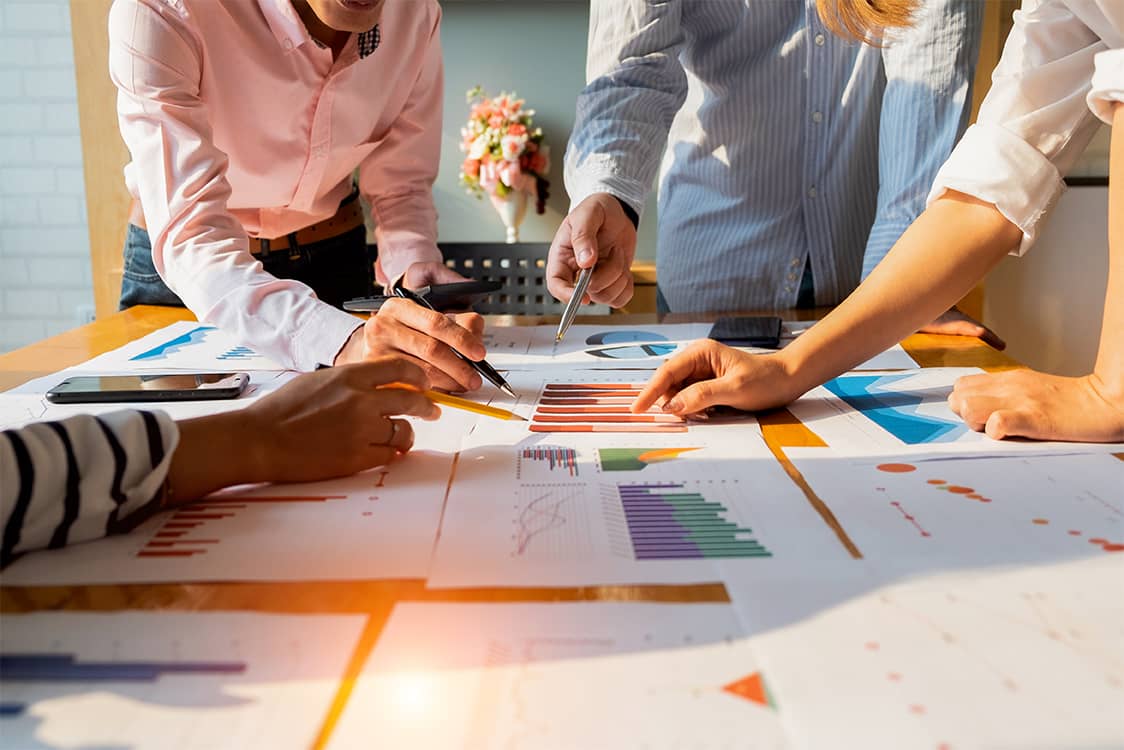 Businesspeople analyzing investment graph